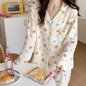 Detail of cream long-sleeved pajama set with cute bear prints and button-down shirt