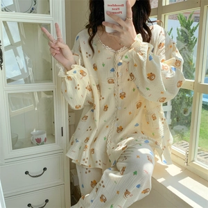Close-up of cotton pajama lace collar with cute brown bear prints and button details