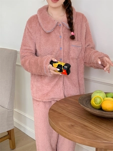Detail of pink flannel pajama set with blue piping and button-down collar