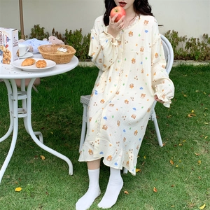 Detail of cream long-sleeved nightgown with cute bear prints and delicate lace collar