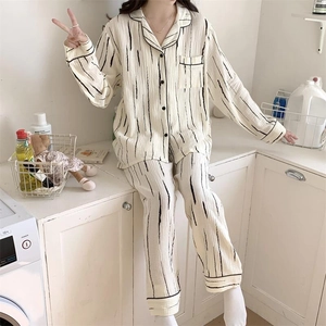Detail of striped pajamas with black piping and buttons in a cozy laundry room setting