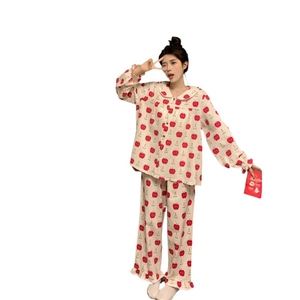 Women's cream pajama set featuring red apple print with ruffles and long sleeves