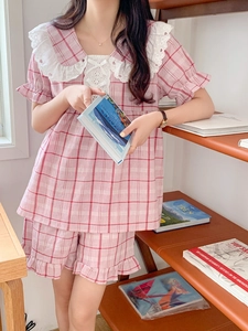 Detailed view of pink plaid pajama set with lace Peter Pan collar and ruffled hems