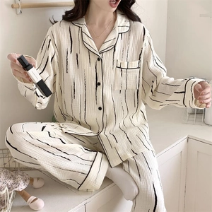Detail of waffle knit pajama set with black vertical stripes and button-down collar