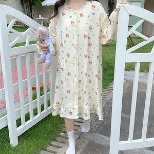 Close-up of lace collar and cartoon bear print on beige long sleeve nightdress