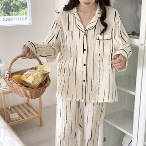 Detail of striped cream pajama set showing textured breathable fabric and buttoned collar