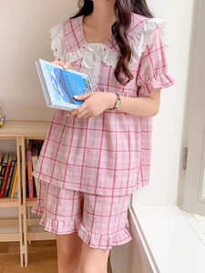 Detailed view of pink plaid pajama set with delicate lace collar and ruffled sleeve hem