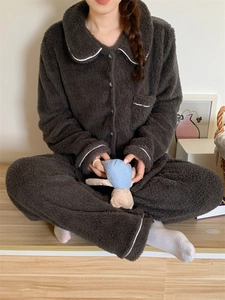 Detail showing plush winter pajama set with white piping and breast pocket