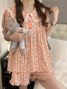 Close-up of lace doll collar and cute bear patterns on orange striped pajama set