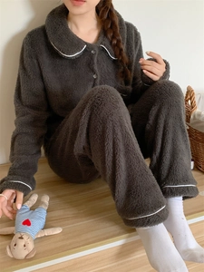Detail of dark gray fleece pajamas with white trim and soft velvet texture