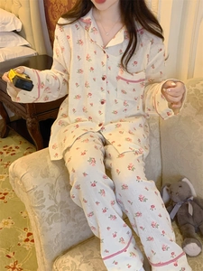 Détail de l'ensemble pyjama en coton à fleurs avec bordures à carreaux rouges et revers