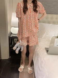 Close-up of peach pajama set with bear prints and delicate white lace collar