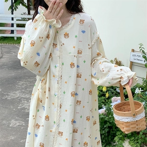 Detail of bear print loungewear with lace trim and elastic cuffs on cream fabric