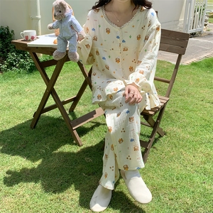 Detail of V-neck lace collar and cartoon bear print on beige long sleeve pajama set