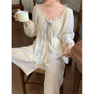 Elegant light yellow pajama set with ruffles and purple bow for women home wear