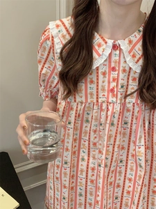 Detailed view of striped pajamas featuring cute teddy bear, heart, and cherry patterns