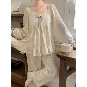 Women's yellow striped pajama set with ruffled edges and bow detail in soft crepe cotton