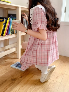 Detailed close-up of the lace collar and pink checkered pattern on the summer pajama set