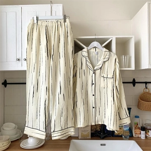Close-up of black and white striped cotton pajama set hanging in a modern kitchen setting