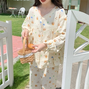 Detail view of lace-trimmed long-sleeve pajamas with cute bear and cloud patterns