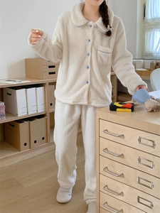 Detail of soft cream fleece pajama set with elegant blue piping and contrast buttons