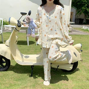 Lace-trimmed V-neck detail on cream pajama set featuring cute bear and floral prints