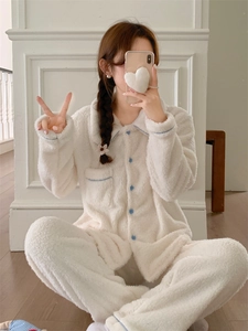 Detail of cream white flannel pajamas with contrast blue piping and button-down front