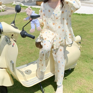 Close-up of sweet bear print pajamas with lace V-neckline and ruffled hem detail