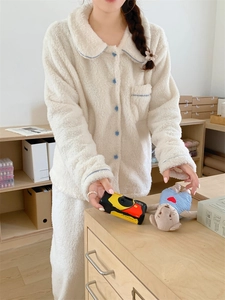 Detail of plush winter pajama set with Peter Pan collar and blue button accents