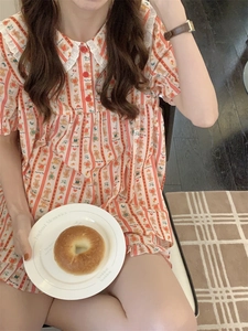 Close-up of cartoon bear pajamas featuring lace Peter Pan collar and ruffled sleeves