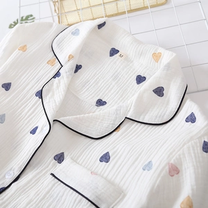 Detail of soft cotton double gauze pajama with heart print and contrast piping trim