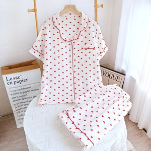 Close-up of cotton pajama set with red heart prints and contrasting red piping detail