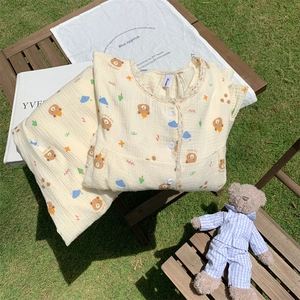 Detailed texture of cotton double gauze fabric with cartoon bear print and lace trim