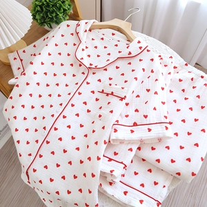 Detail of soft cotton gauze women pajamas featuring a red heart print and M size label