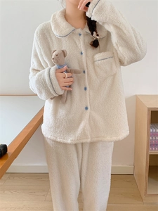 Detail of white double-sided fleece pajamas set with blue piping and soft texture