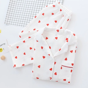 Detailed view of white cotton pajama set with red heart prints and button-down collar