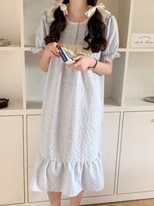Détail d'une chemise de nuit vichy bleu clair avec col en dentelle et boutons simples