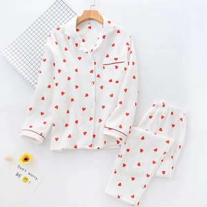 Detail of soft cotton pajama set with red heart print and button-down collar design