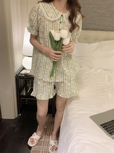 Detail of cute green bear print pajama set with lace doll collar and ruffled shorts hem