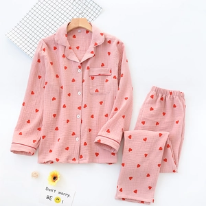 Close-up of pink cotton crepe pajamas with red heart pattern and button-down collar
