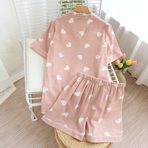 Detailed view of pink heart print cotton pajamas set with white piping and lapel collar