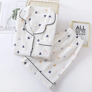 Women's white cotton pajama set with colorful heart print and black piping trim