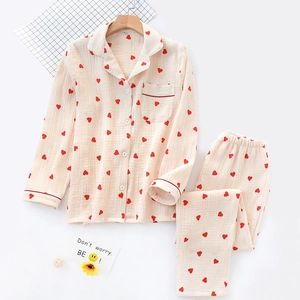 Detail of soft cotton crepe pajama set featuring red heart prints and piping accents