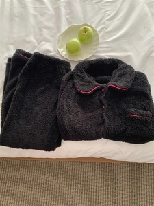 Detail of winter thermal fleece pajama set with pink contrast piping and soft plush texture