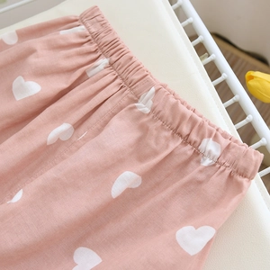 Detail of elastic waistband on pink cotton pajamas with white heart pattern