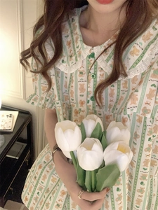 Close-up of cute cartoon bear print and white lace collar on women pajamas