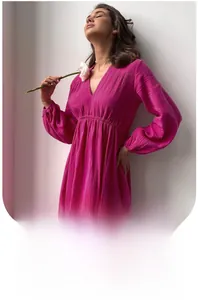 Detail view of rose pink crepe fabric texture and V-neckline of long sleeve robe