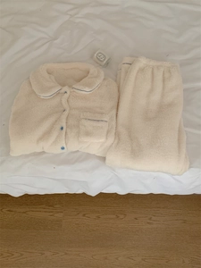 Detail view of cream white flannel pajama set with blue piping and button-up lapels