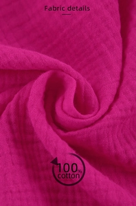 Close-up of 100% cotton double gauze fabric in dark pink showing soft crinkled texture
