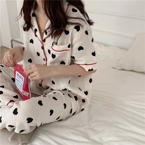 Close-up of heart pattern cotton pajamas with red contrast trim and breathable texture